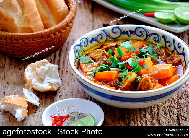 Vietnam food, bread with stewed beef, a popular meal at morning, eat attach parsley, basil, lemon pepper and salt make so delicious taste