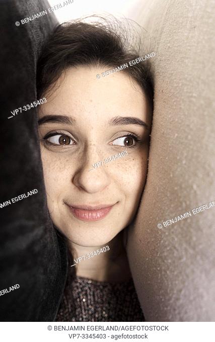 young woman with head between pillows