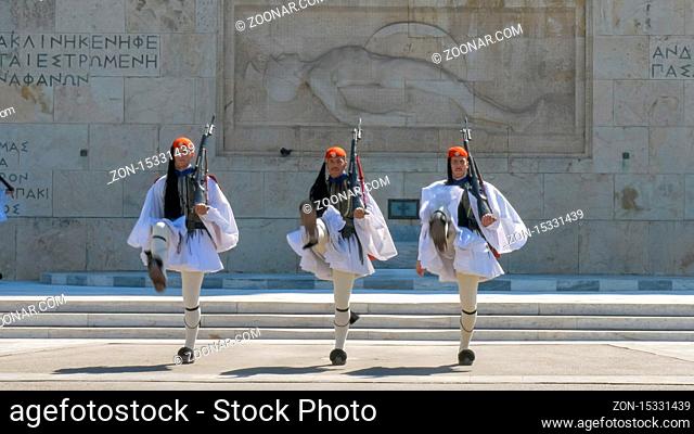ATHENS, GREECE- SEPTEMBER, 4, 2016: three guards walk towards the camera at the changing of the guard ceremony at the greek parliament in athens, greece