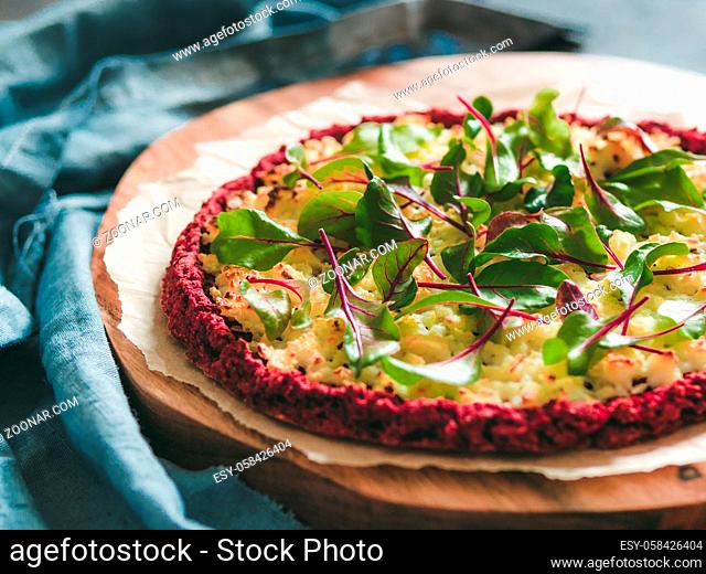 beetroot pizza crust with fresh swiss chard or mangold, beetroot leaves. Ideas and recipes for vegan snack.Egg-free pizza crust with chia seeds and wholegrain...
