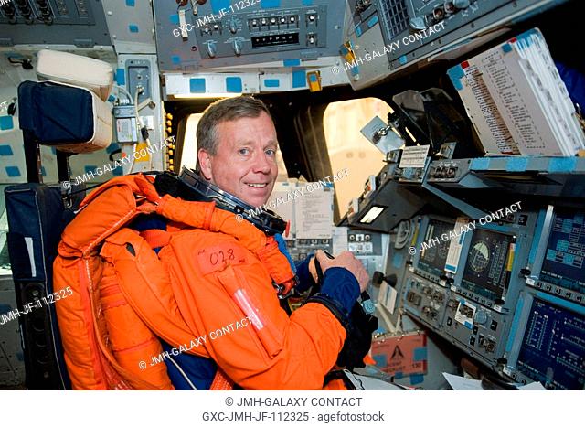 While seated at the commander's station, NASA astronaut Steve Lindsey, STS-133 commander, participates in a post insertionde-orbit training session in the crew...