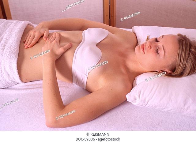 woman treating her stomache  F. X. Mayr  against intestinum disorders