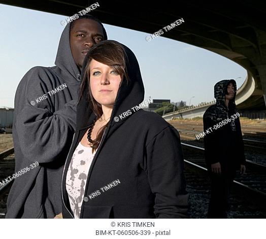 Group of young adults standing under raised highway