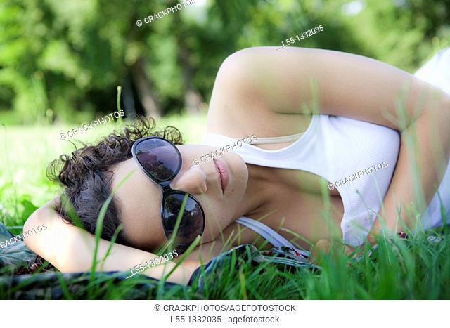 Woman lying down on grass