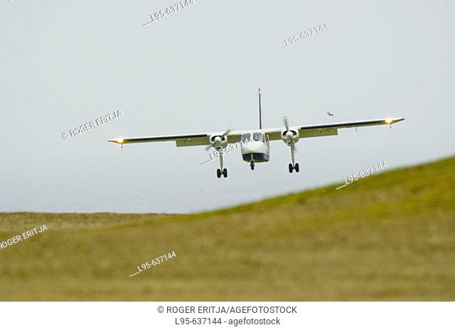 Small aircraft shuttle between Shetland islands landing at Fair Isle landing ground