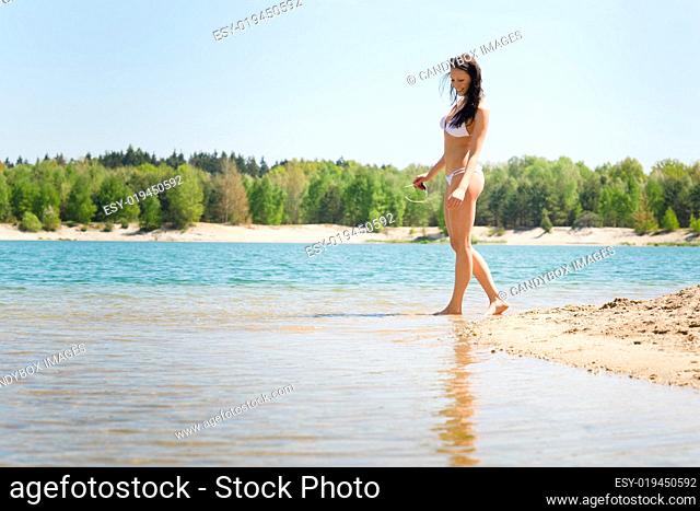 Summer beach woman walk sand wear bikini