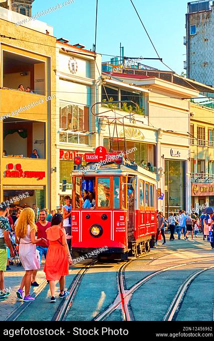 Istanbul, Turkey - July 18, 2018: Historic old tram and walking people in Istiklal pedestrian street in Istanbul