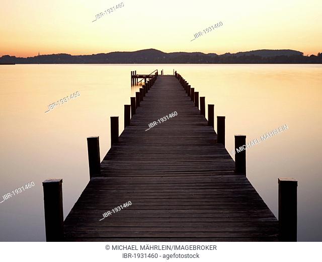 Pier in Lake Woerthsee at sunrise, Bavaria, Germany, Europe