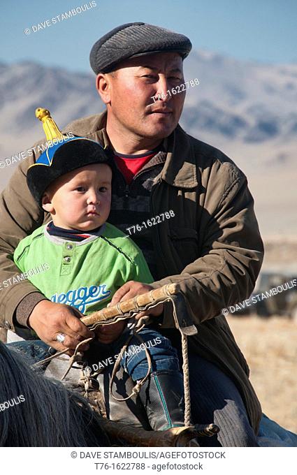 Kazakh father and son on horseback in Bayan-Ölgii in Western Mongolia