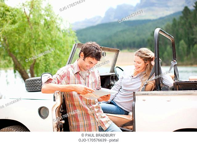 Couple in vehicle looking at map