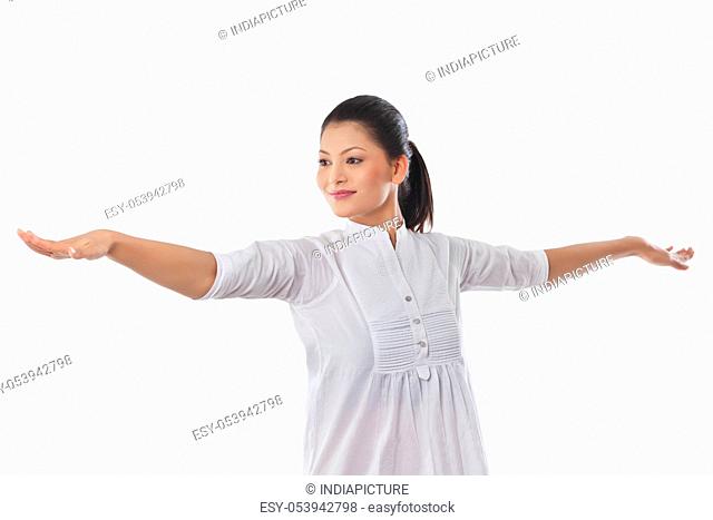 Young smiling woman with arms outstretched