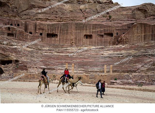 amels carry tourists along the long paths in the rock town of Petra. The theatre, which once accommodated 7, 000 people, is part of the extensive complex