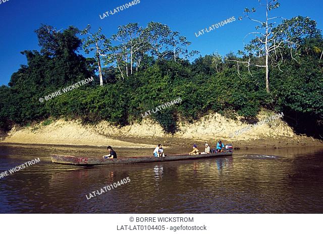 National park. River Madidi. Amazon basin. People in dug out boat, canoe. Forest, jungle, trees, vegetation