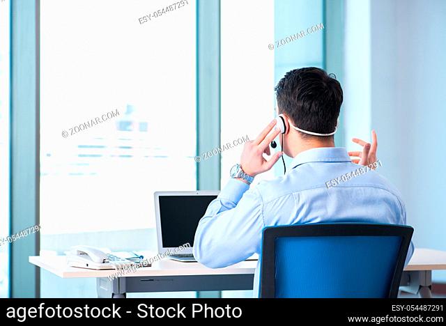 The male call-center operator in business concept