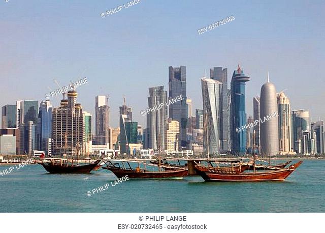 Skyline of Doha with traditional arabic dhows. Qatar, Middle East
