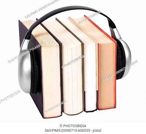 Close-up of books with headphones