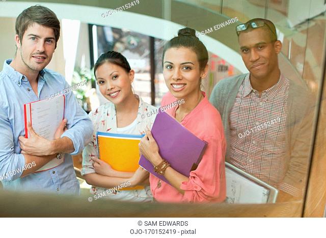 Portrait of smiling business people with folders