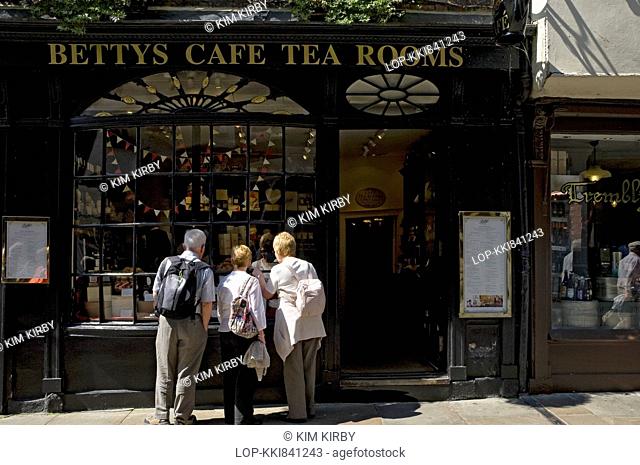 People looking in the window of Little Bettys cafe and tea rooms in Stonegate