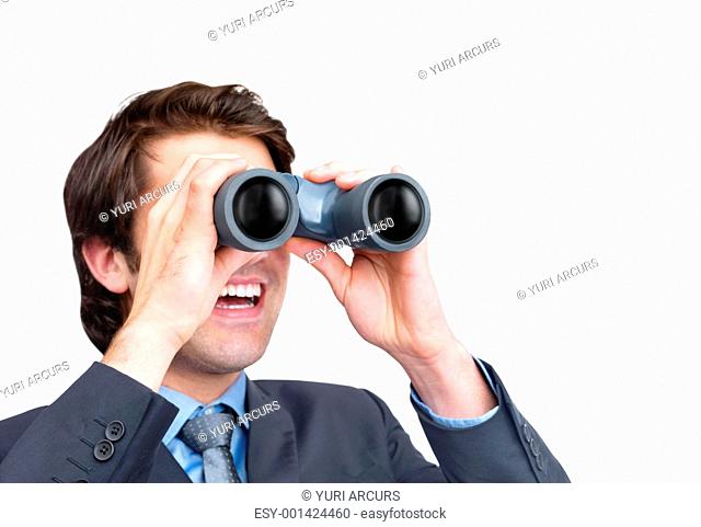 Closeup of a happy young male entrepreneur looking through binoculars against white background
