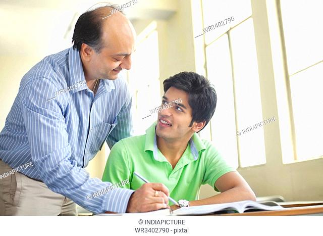 Teacher assisting student in classroom