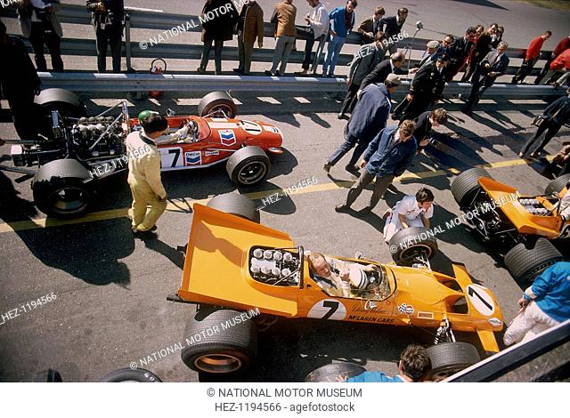 Denny Hulme's McLaren Ford at the British Grand Prix, Silverstone, Northamptonshire, 1969. Hulme's is the orange car in the foreground