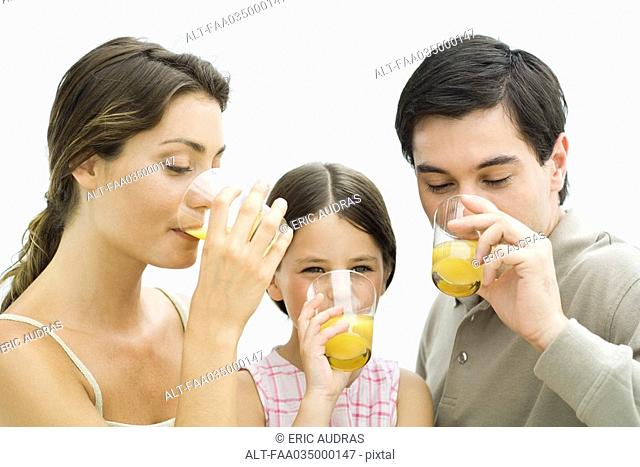Family drinking orange juice together