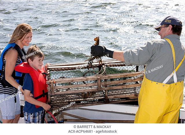 Young boy and mother talking to Lobster fisherman, Northport, Prince Edward Island, Canada