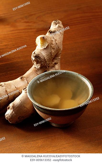 Cup of ginger tea and fresh ginger