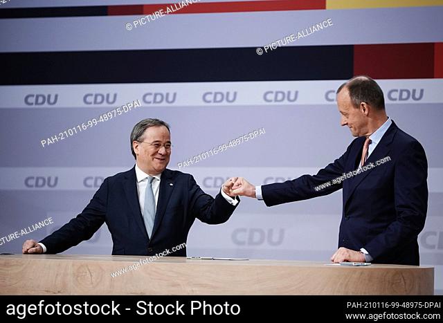 16 January 2021, Berlin: The defeated Friedrich Merz (r) congratulates Armin Laschet on his election as party leader at the digital federal party conference of...