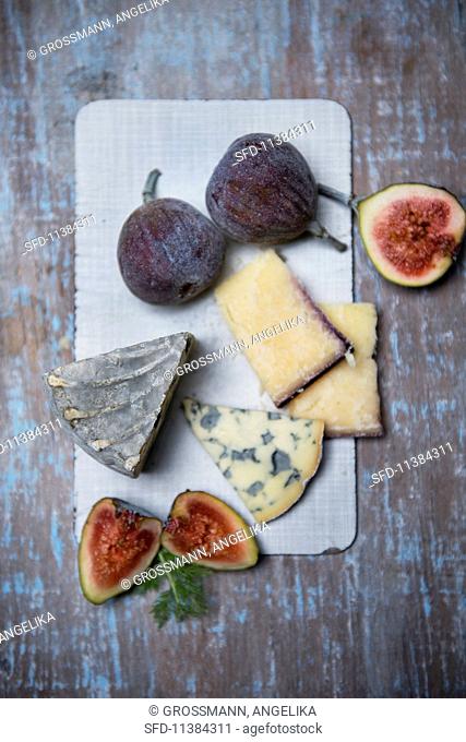 Fourme D'Ambert (French blue cheese) wine hard cheese from Italy with figs and fennel leaves