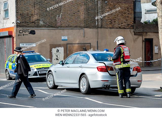 Police man the inner cordon on the Grange in London's Bermondsey, roughly 400 metres away from a WWII bomb discovered earlier this morning