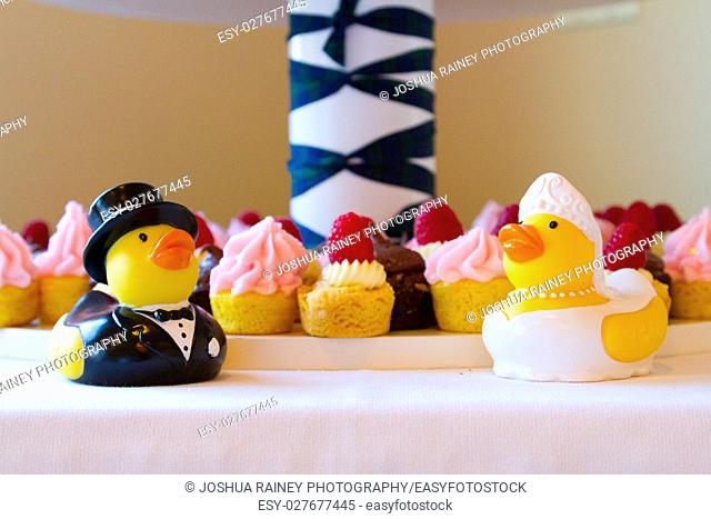 Cupcakes at a wedding reception with rubber duckies in front