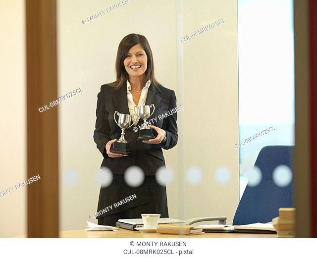 Woman holding trophies
