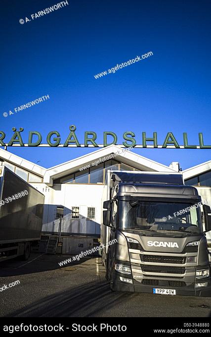 Stockholm, Sweden Trucks parked at the Arsta Partihallarna wholesale market in Arsta. Sign in Swedish: ""Gardening hall. ""