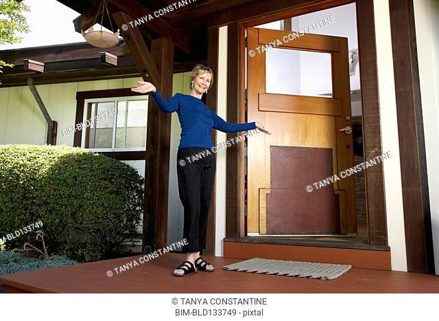 Senior Caucasian woman standing on front porch