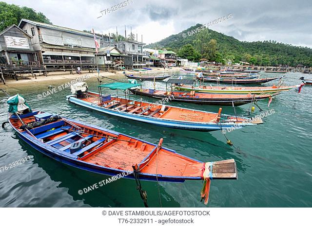 longtail boats during the monsoon in Mae Haad Bay, Koh Tao, Thailand