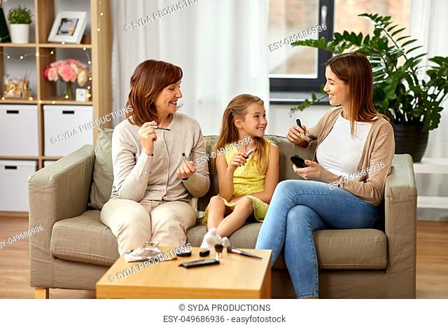 mother, daughter and grandmother doing make up