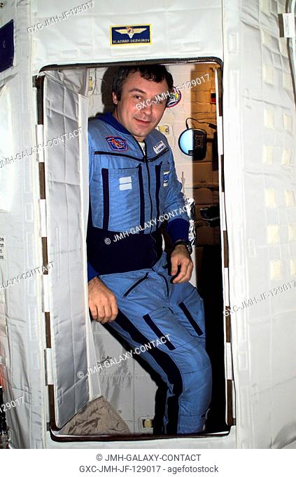 Cosmonaut Vladimir N. Dezhurov, Expedition Three flight engineer, takes a break from a busy day in the Temporary Sleep Station (TSS) in the Destiny laboratory...