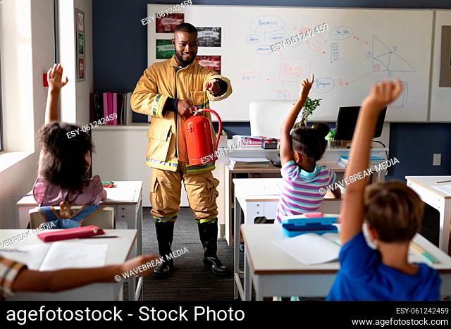 African american young male teacher pointing on multiracial elementary students in safely education