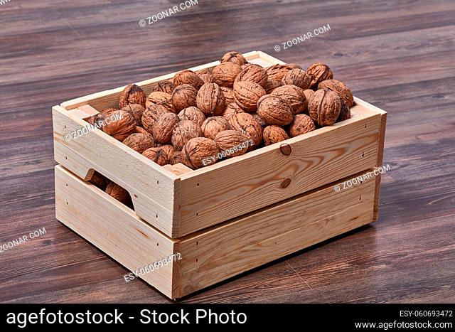 Pile of walnuts in a wooden bin