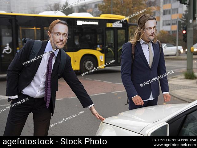 16 November 2022, Berlin: Activists of the environmental protection group ""Last Generation"" wear masks with the likeness of Federal Finance Minister Lindner...