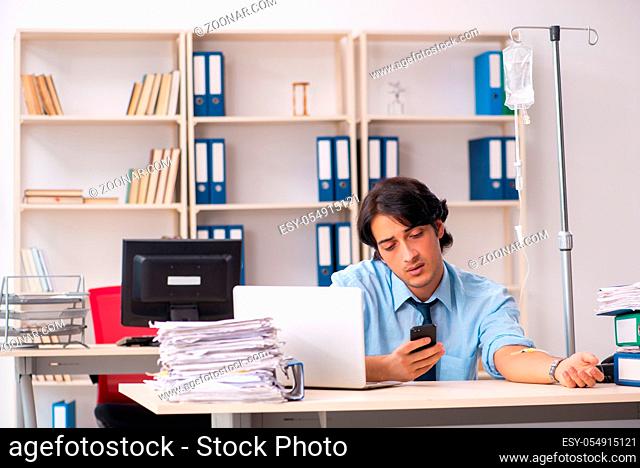 Young male employee in blood transfusion concept