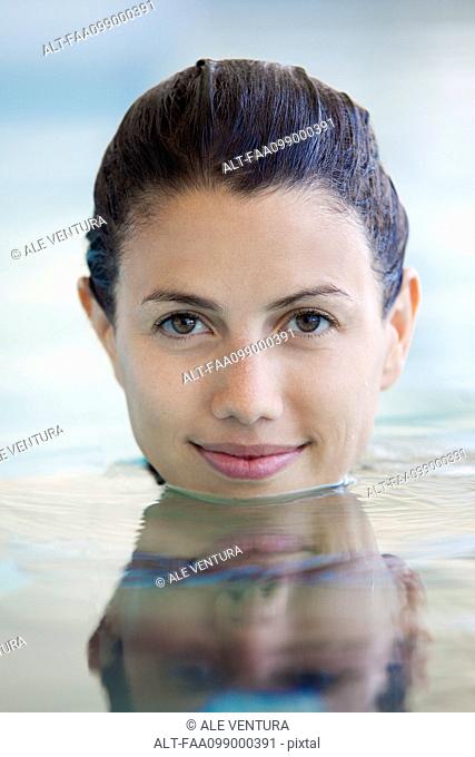 Woman relaxing in swimming pool, portrait