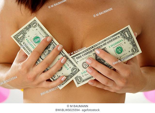 young woman hiding her naked bosom with two banknotes