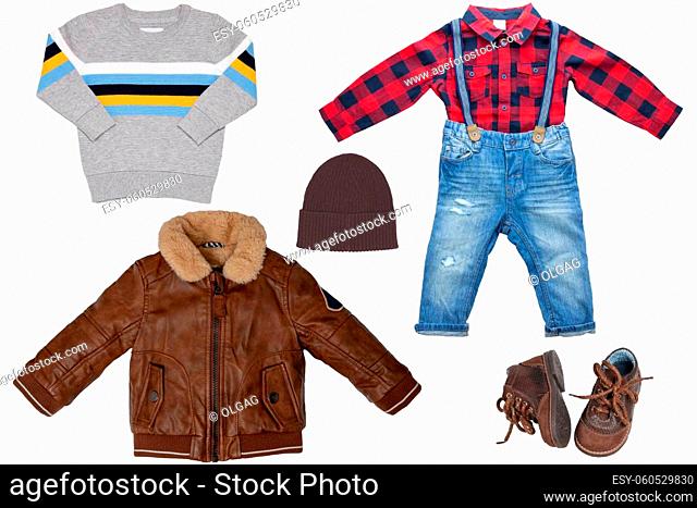 Collage set of little boy autumn clothing isolated on a white background. Denim trouser with plaid shirt, a pair shoes, a leather jacket and pullover or sweater...