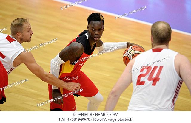 Germany's Denis Schroeder and Poland's Przemyslaw Karnowski (R) vie for the ball during the basketball Supercup game between Germany and Poland at the...