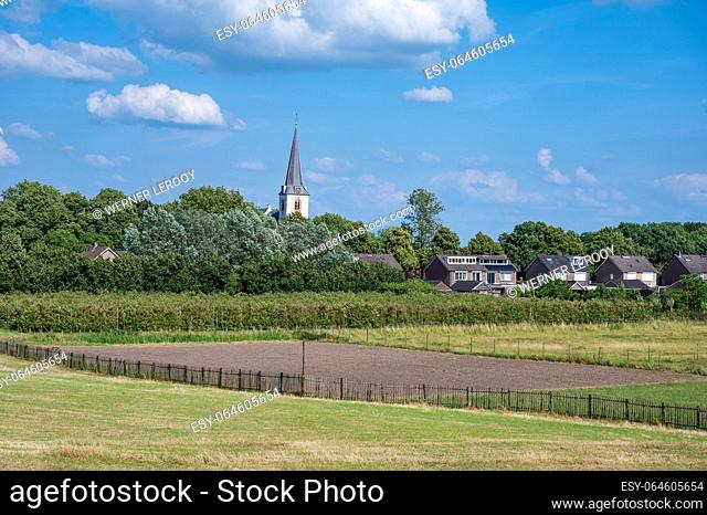 Countryside landscape view over the agriculture fields with the church tower in the background around Rijswijk, Gelderland, The Netherlands