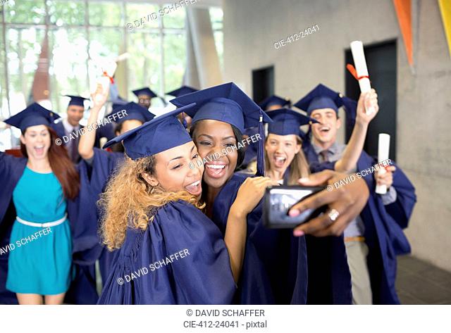 Students taking selfie after graduation ceremony