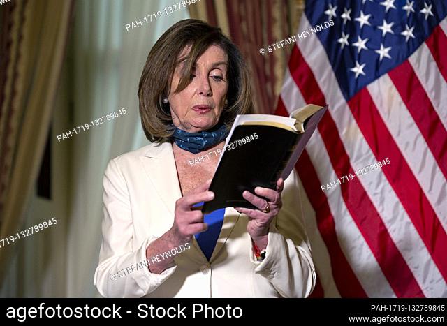 Speaker of the United States House of Representatives Nancy Pelosi (Democrat of California) reads an excerpt from the Bible following a bill enrollment ceremony...