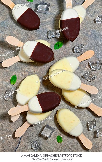 Ice cream in chocolate and white chocolate glaze on a stick